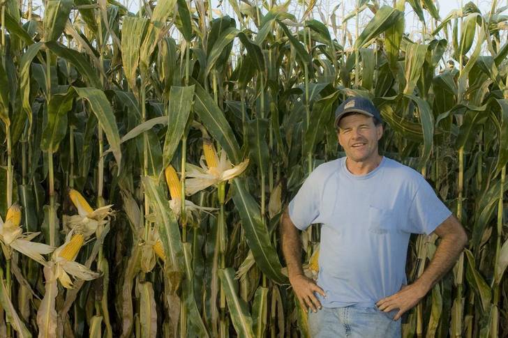 Photograph of farmer Phil Johnson in front of fields